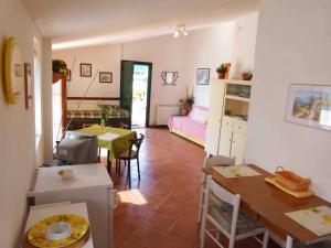 a living room with a kitchen and a dining room at Un Posto al Sole in Diano San Pietro
