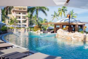a swimming pool at a resort with a resort at Garza Blanca Preserve Resort & Spa in Puerto Vallarta