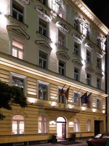 a building with flags on the side of it at Hotel Assenzio Prague in Prague