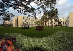 a large building with a green lawn in front of it at Le Passage Cairo Hotel & Casino in Cairo