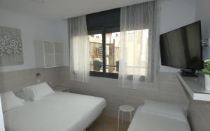 Posteľ alebo postele v izbe v ubytovaní Hostal House