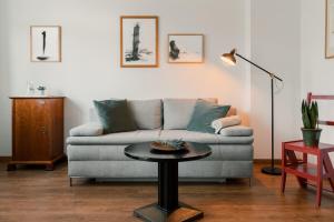 a living room with a couch and a table at Hotel Esplanade in Gmunden