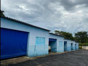 a row of blue garage doors on a building at Aquarius Motel IV in Araraquara