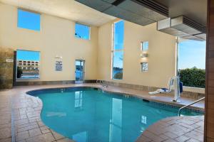 a swimming pool in a building with a large window at Oxford Suites Silverdale in Silverdale