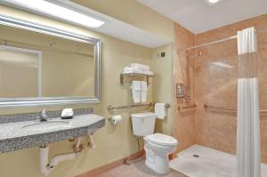 a bathroom with a toilet and a sink and a shower at Hotel Nexus; BW Signature Collection in Seattle