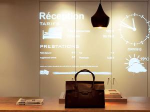 a bag sitting on a table in front of a window at ibis Hyeres Centre in Hyères