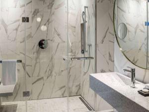 a bathroom with a shower with a glass door at Sofitel Roma Villa Borghese in Rome