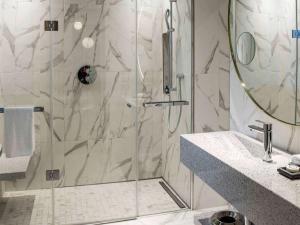 a bathroom with a shower with a glass door at Sofitel Roma Villa Borghese in Rome
