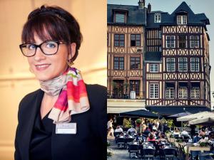 a woman wearing glasses and a scarf holding a beach ball at Mercure Rouen Centre Cathédrale in Rouen