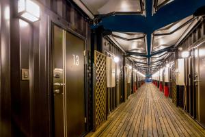 a long hallway with red cones on the side of a train at HOTEL R9 The Yard Kanuma Sakae in Kanuma