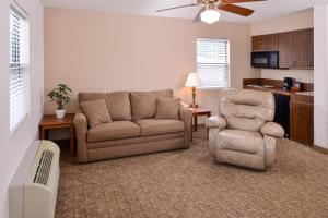 a living room with a couch and a chair at Briarwood Inn Of Geneva in Geneva