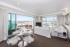 a living room with a couch and a table at Princes Wharf 2BR Sub-Penthouse in Auckland