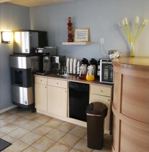 a kitchen with a counter with a stove and appliances at Grand Forks Inn in Grand Forks