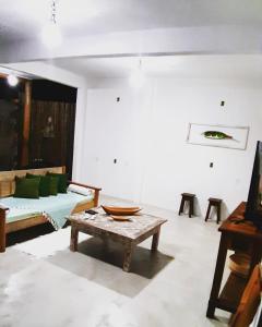 een woonkamer met een tafel en een bank bij Pousada Amor de Casa in Trancoso