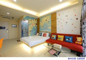 a bedroom with a bed and a red couch at 85 Asia Hotel in Kaohsiung