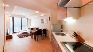 a kitchen with a table and a dining room at Akazora in Niseko