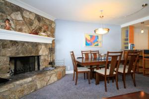 a dining room with a table and a fireplace at Mountainback 062 in Mammoth Lakes