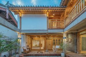 a large house with wooden ceilings and a patio at SuShe Inn（2nd Jianshe Inn) in Lijiang