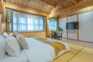 מיטה או מיטות בחדר ב-SuShe Inn（2nd Jianshe Inn)