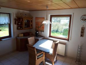 a kitchen with a table and chairs and a window at Ferienhaus "Werrablick-Frankenroda" in Frankenroda