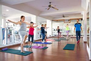 a group of people doing yoga in a gym at Vitalclass Lanzarote Resort in Costa Teguise