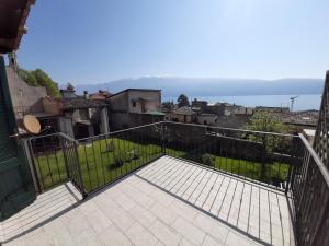 einen Balkon eines Hauses mit Blick auf das Wasser in der Unterkunft La Petite Maison in Gargnano