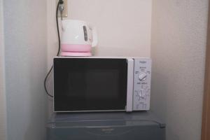 a blender sitting on top of a microwave at KYOBASHI BASE in Osaka