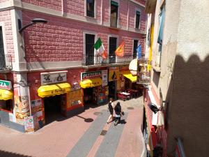 two people walking down a street in front of a building at Apartaments Yaco in Lloret de Mar