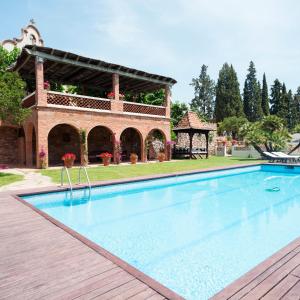 a large swimming pool in front of a house at Can Borrell in Castellar