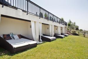 a row of couches sitting on the grass at Can Borrell Villa Carmen in Castellar
