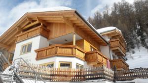 a house with wooden balconies on top of it at Pension Angern in Obergurgl