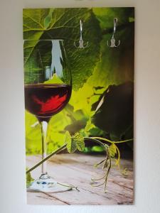 a glass of red wine sitting on a table at Am Badischen Weinberg in Hagnau