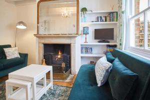 a living room with a couch and a fireplace at Host & Stay - Gun Gutter House in Staithes