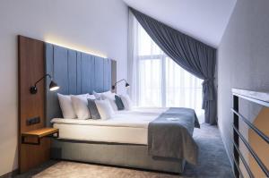 מיטה או מיטות בחדר ב-Green Mountain 5* Hotel