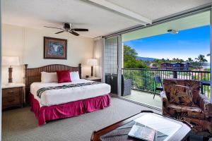 a bedroom with a bed and a balcony at Mana Kai 410 - Ocean front at Keawakapu Beach, AC in Wailea +59 photos