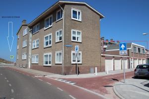 a large brick building on the side of a street at Appartement 5 in Katwijk aan Zee