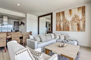 a living room with a couch and a table at Luxe Cabo Condo w/ Ocean Views + Amenities! in Cabo San Lucas