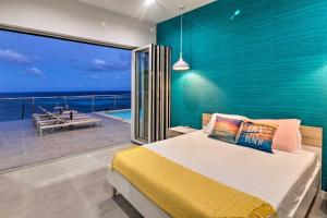 A bed or beds in a room at Luxury St Croix Home with Oceanfront Pool and Views