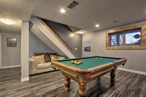 a room with a pool table and a couch at Whispering Pines Cabin with Pool, Lake and Golf Access! in Pine Lake