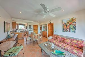 a living room with a couch and a table at Cabo Condo with Balcony, Ocean Views and Resort Perks! in Cabo San Lucas