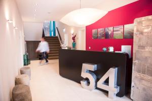 a woman walking in a room with a large at Villa 54° Nord in Westerland (Sylt)