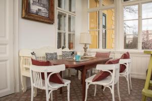 a dining room with a wooden table and chairs at Polyák villa in Révfülöp