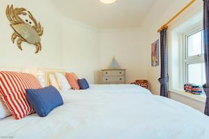 a bedroom with two white beds and a window at Driftwood Cottage by Bloom Stays in Folkestone