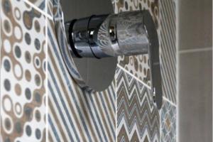 a shower curtain with a blow dryer attached to a wall at Manoir du Bois Mignon Luxury Home - Dordogne in Le Fleix