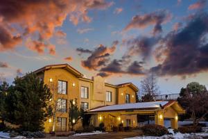 a yellow building with a cloudy sky behind it at La Quinta Inn by Wyndham Denver Northglenn in Westminster