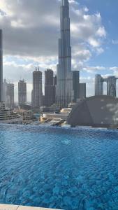 a large pool of water in front of a city at BELLEVUE Downtown Dubai in Dubai
