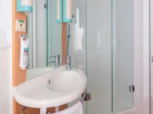 a bathroom with a sink and a shower at Ibis Brussels City Centre in Brussels