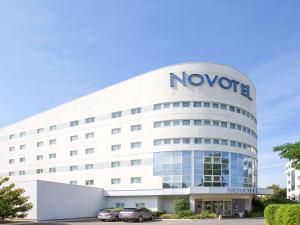 a large building with a large clock on the front of it at Novotel Paris Orly Rungis in Rungis