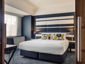 Postel nebo postele na pokoji v ubytování Mövenpick Hotel Auckland