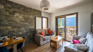 ein Wohnzimmer mit einem Sofa und einem Tisch in der Unterkunft L'O Rouge - Apt A102 - BO Immobilier in Châtel